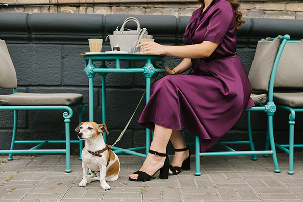 Dog and Lady sat outside at a table - City Breaks