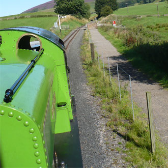 Green train on railway track Green train on railway track